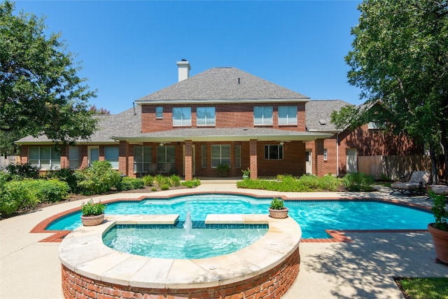 view of swimming pool featuring an in ground hot tub, a patio, and pool water feature