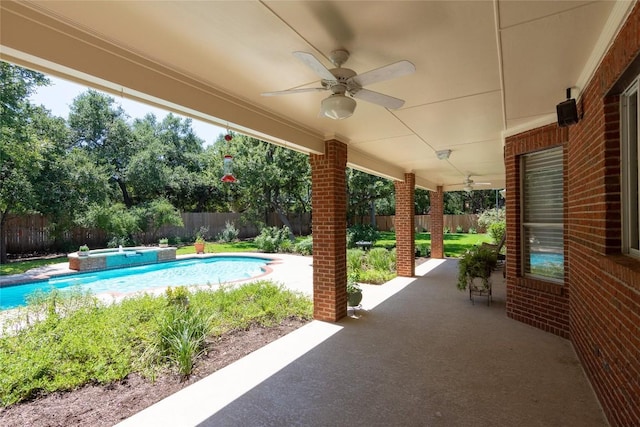 view of patio featuring ceiling fan, a fenced backyard, and a pool with connected hot tub