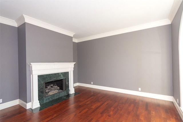 unfurnished living room featuring wood-type flooring, a fireplace, and ornamental molding