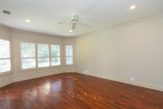 empty room featuring dark hardwood / wood-style floors, crown molding, and ceiling fan