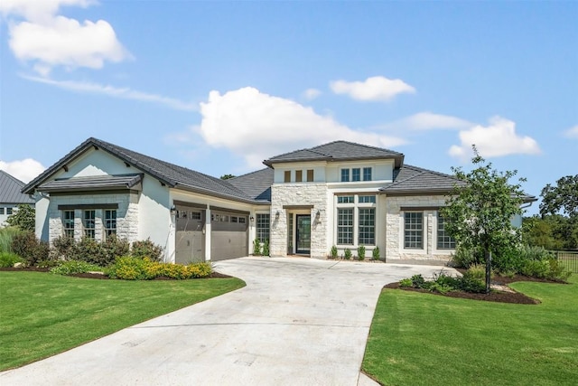 view of front of property featuring a front yard and a garage