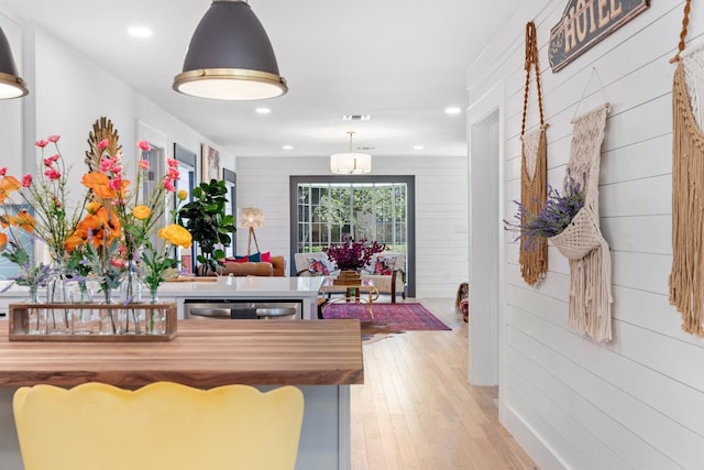 game room featuring wood walls and light hardwood / wood-style floors