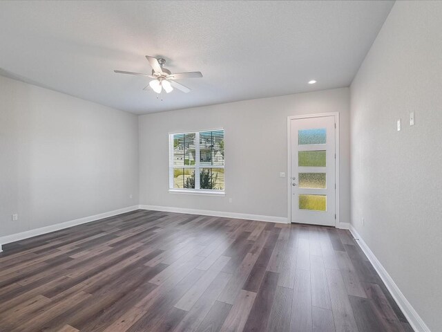 unfurnished room featuring recessed lighting, ceiling fan, baseboards, and dark wood-type flooring