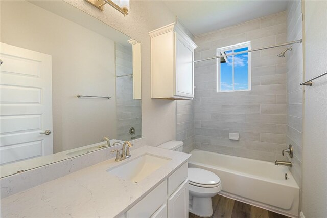 bathroom featuring vanity, shower / tub combination, wood finished floors, and toilet