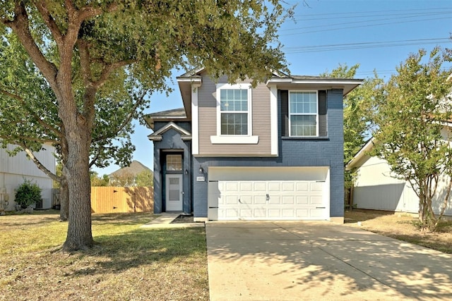 traditional-style house featuring fence, an attached garage, a front lawn, concrete driveway, and brick siding