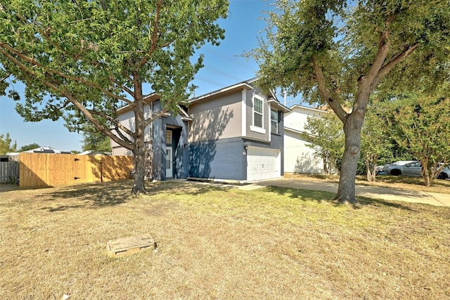 view of front of house with brick siding, fence, concrete driveway, a front yard, and an attached garage