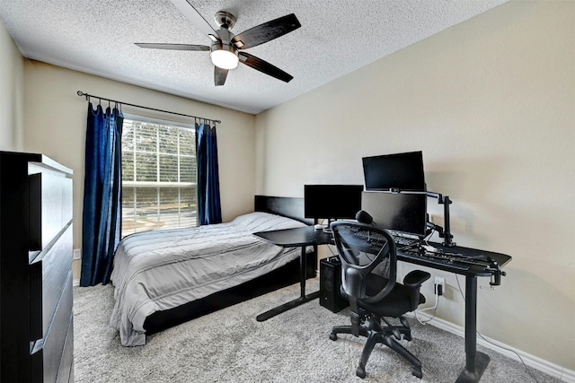 carpeted bedroom featuring a textured ceiling, baseboards, and a ceiling fan