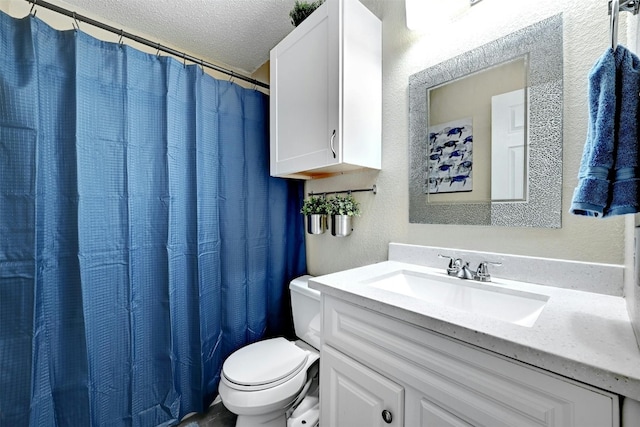 full bathroom featuring a textured wall, a textured ceiling, vanity, and toilet