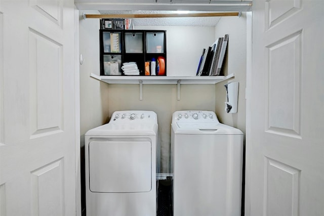 washroom featuring laundry area and washing machine and clothes dryer