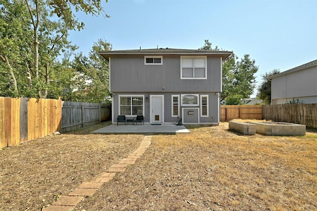 back of property featuring a fenced backyard and a patio