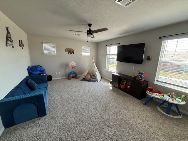 rec room featuring carpet flooring, a textured ceiling, and ceiling fan