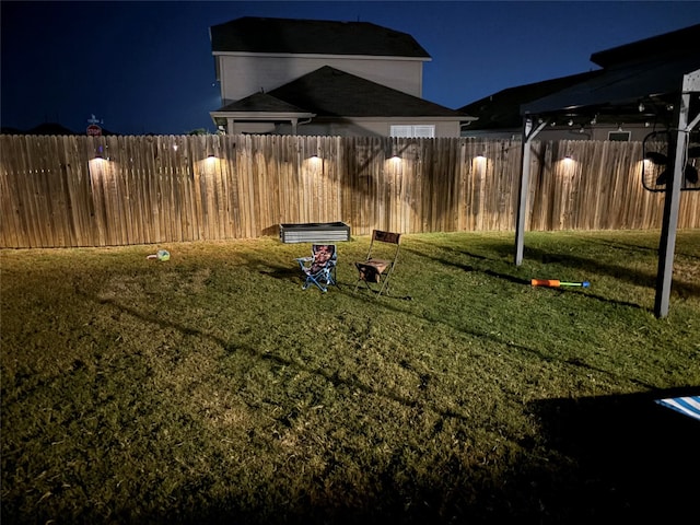 view of yard at twilight