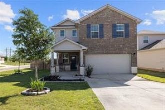 view of front facade featuring a front yard and a garage