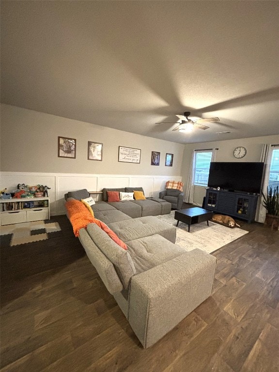 living room featuring dark hardwood / wood-style floors and ceiling fan