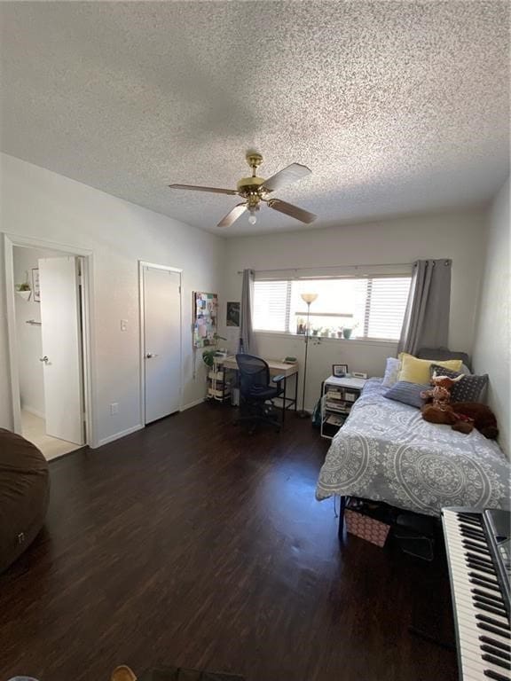 bedroom featuring ceiling fan, a textured ceiling, and dark wood-type flooring