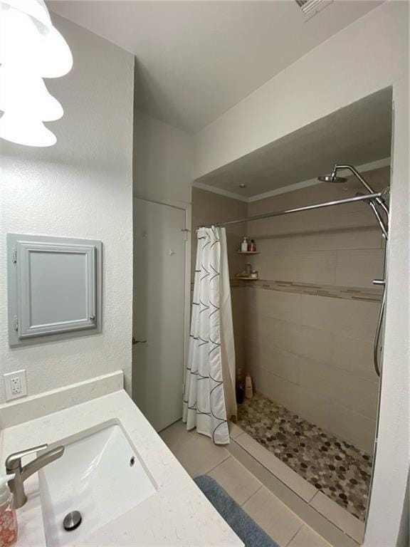 806 W 24th St Unit 214, Austin, TX 78705 - bathroom featuring a stall shower, vanity, and tile patterned flooring