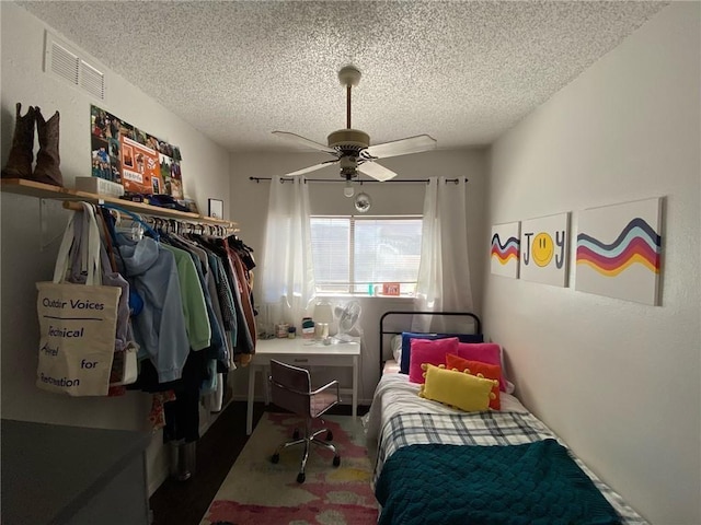 806 W 24th St Unit 214, Austin, TX 78705 - bedroom with a textured ceiling and a ceiling fan
