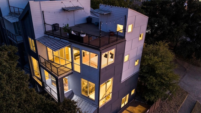 rear view of house featuring a balcony