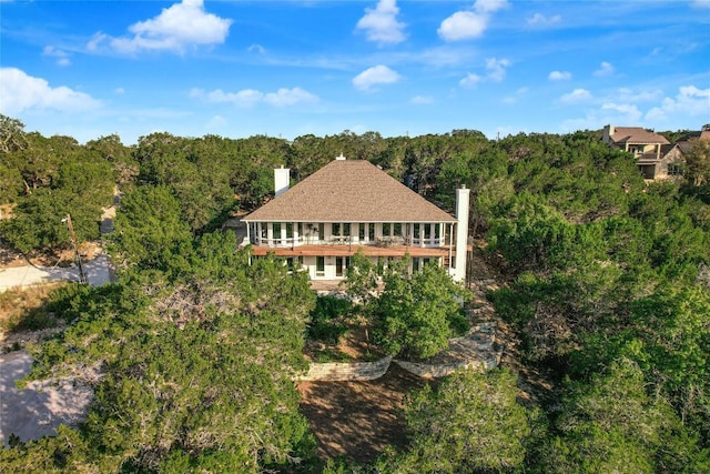 aerial view featuring a wooded view