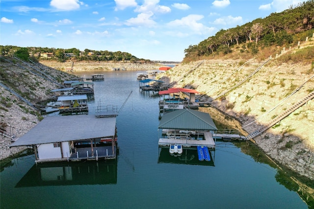 dock area with boat lift and a water view