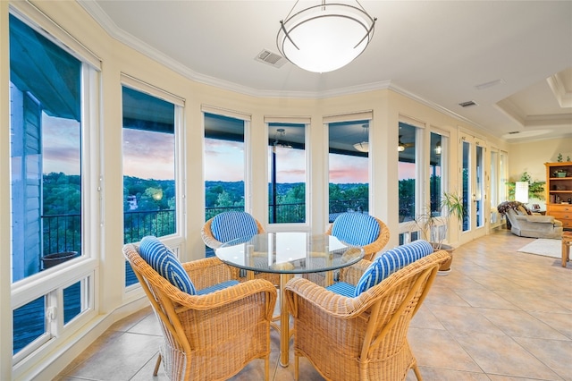 sunroom featuring visible vents and a healthy amount of sunlight