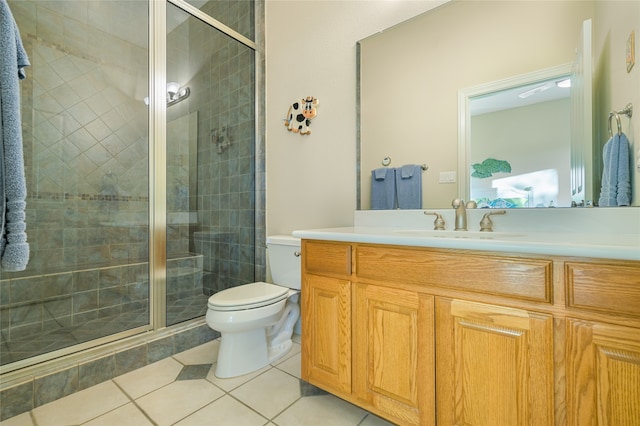 bathroom featuring vanity, walk in shower, tile patterned floors, and toilet