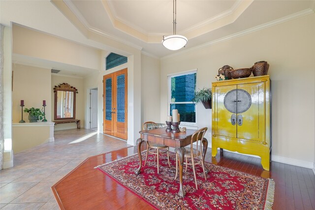 dining space featuring french doors, crown molding, hardwood / wood-style floors, and a tray ceiling