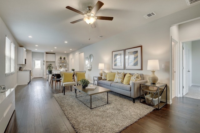 living room with dark hardwood / wood-style floors and ceiling fan