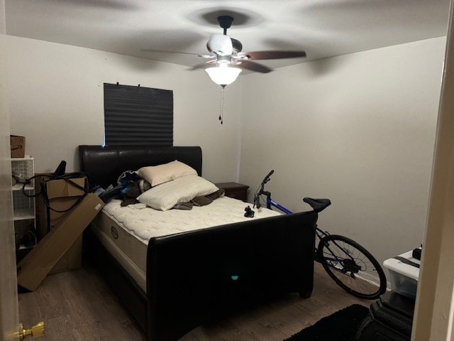 bedroom featuring ceiling fan and dark hardwood / wood-style flooring