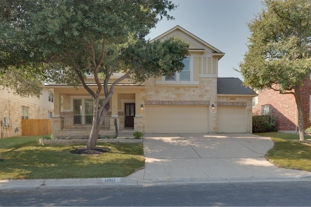 view of front of property with a garage, a front lawn, and covered porch