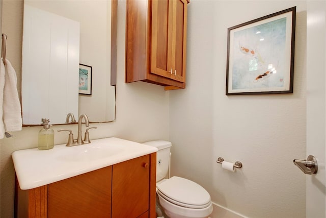 bathroom with toilet and vanity