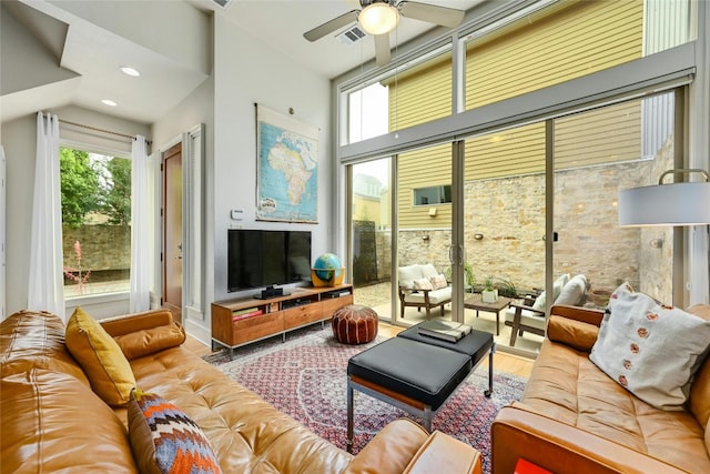 living room featuring ceiling fan and hardwood / wood-style floors