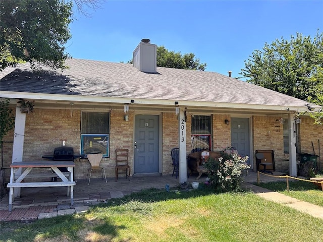 ranch-style house with a front yard and covered porch