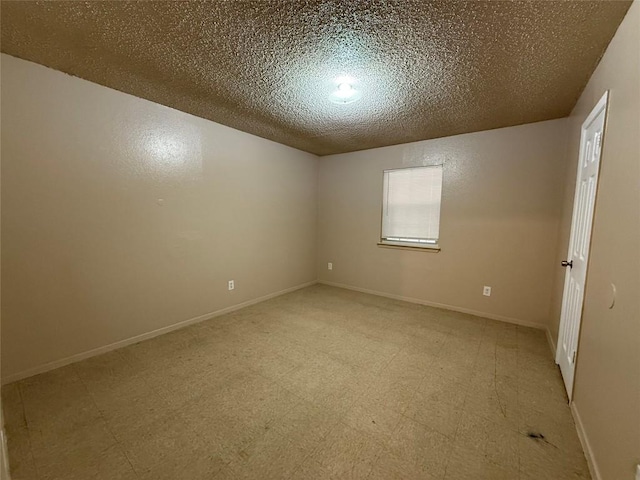 unfurnished room featuring a textured ceiling