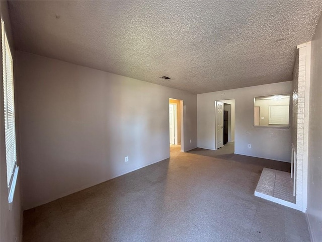 unfurnished room featuring a textured ceiling