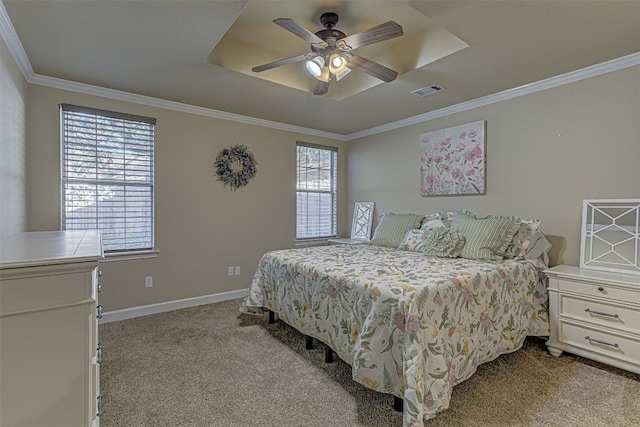 bedroom with crown molding, ceiling fan, a tray ceiling, and light colored carpet