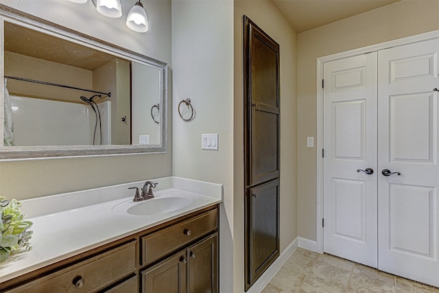 bathroom with tile patterned floors, a shower with shower curtain, and vanity