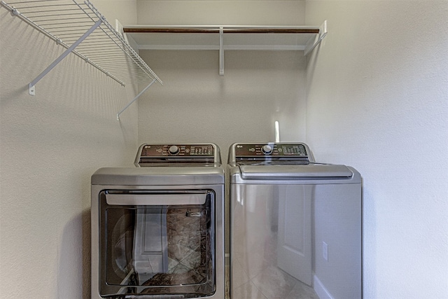 clothes washing area with independent washer and dryer