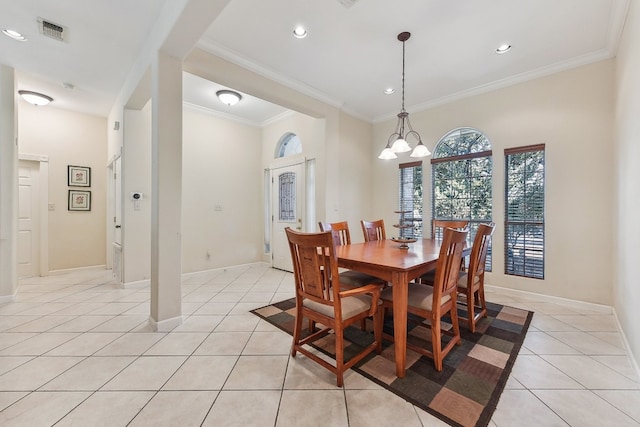 tiled dining area with a notable chandelier and ornamental molding