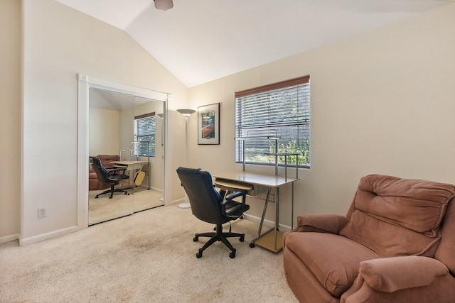 carpeted home office with lofted ceiling