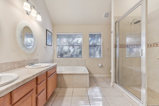 full bathroom with tile patterned flooring, toilet, vaulted ceiling, shower with separate bathtub, and vanity