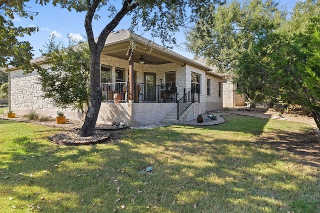 exterior space with a front yard and ceiling fan