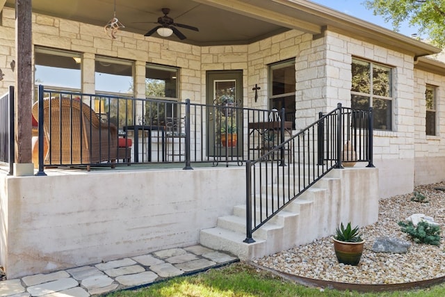 property entrance with ceiling fan