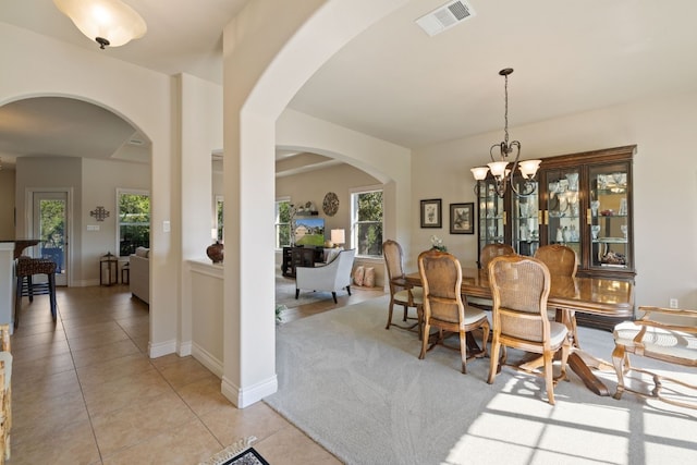 dining room with an inviting chandelier and light tile patterned floors