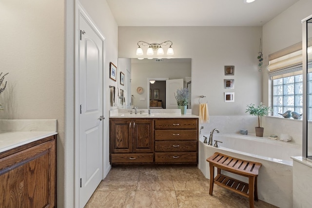 bathroom with a tub to relax in and vanity