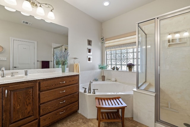 bathroom with tile patterned flooring, shower with separate bathtub, and vanity