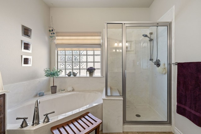 bathroom featuring shower with separate bathtub