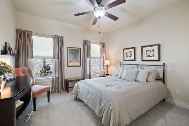 bedroom with ceiling fan and light carpet