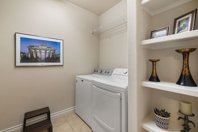 laundry room with independent washer and dryer and light tile patterned floors