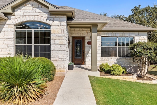 doorway to property featuring a yard